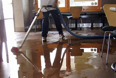 Water Damage Restoration in Philadelphia, Pa - Technician Cleaning Up Water Image